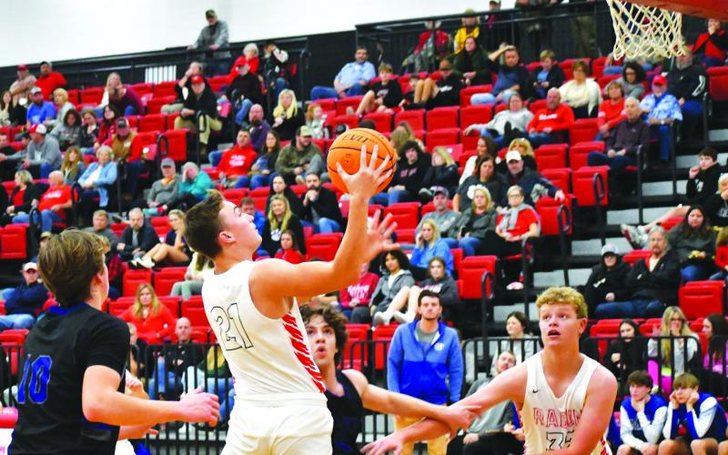 Luke Morey/The Clayton Tribune. With junior Jack Hood looking on, junior Paul Picciotti attacks the basket on Friday night against Banks County. Picciotti and Hood are two of the six athletes who joined the basketball season later due to football season continuing past Thanksgiving.