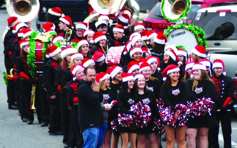 Enoch Autry/The Clayton Tribune. The Rabun County High School Marching Wildcat band members are in good spirits as they see people they know before the start of the Clayton Christmas Parade on Main Street on Dec. 3.