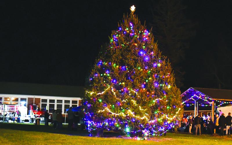 Megan Broome/The Clayton Tribune. Crowds of people turned out to Dillard City Hall on Sunday to attend the City of Dillard’s Christmas Tree lighting event. The colorful tree shined brightly in the evening sky as community members enjoyed fun, fellowship, caroling and good food. 
