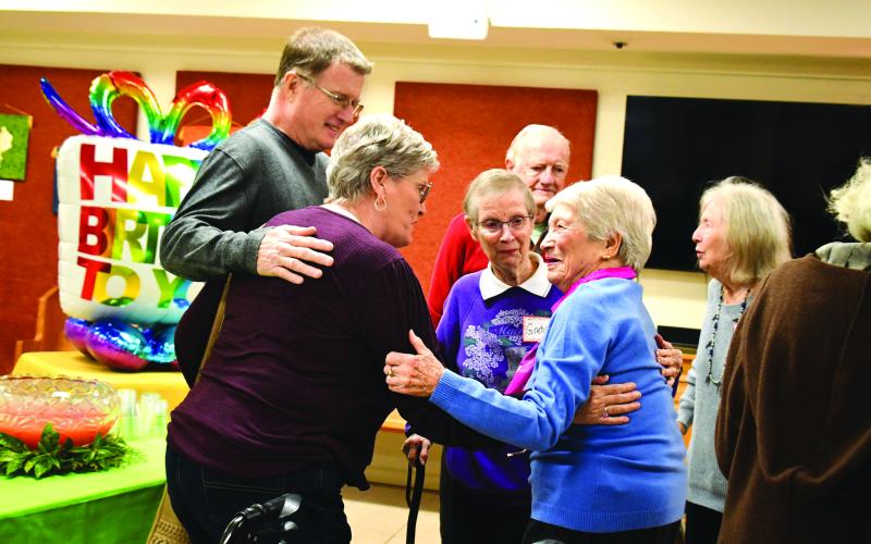 Megan Broome/The Clayton Tribune.  Allie Moseley, right, shows a huge grin as she excitedly meets and greets friends Gretchen Newhall, Ted Newhall, Bob McCrary, Carol McCrary and Rosanne Dibble during her Dec. 5 birthday party.