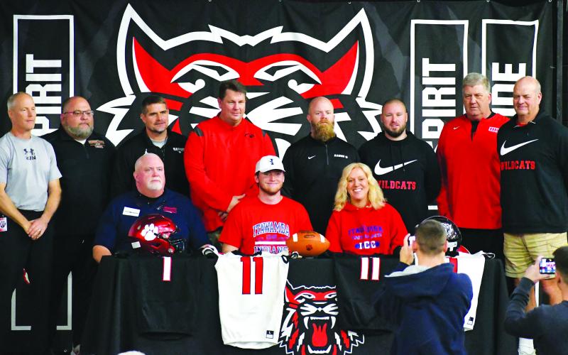 Luke Morey/The Clayton Tribune. Keegan Stover signed with Itawamba Community College in Mississippi on Wednesday, Feb. 1. Seated with Stover are parents Craig and Gail. Standing from left to right are coaches: Tim Corbett, Gregory Baloga, Ricky Ross, Michael Davis, Caleb Bagley, Clay Worley, Eric Richeson, and Jim Pavao.  
