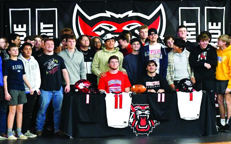 Luke Morey/The Clayton Tribune. Joined by their football teammates, Rabun County seniors Keegan Stover (seated left) and Nicholas Baloga signed to play at the college level on Wednesday, Feb. 1. Stover and Baloga both led Rabun County to a 12-1 record in the senior season.