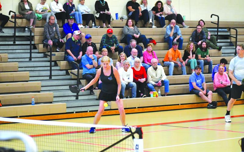 Luke Morey/The Clayton Tribune. Rabun Pickleball Club member Sonja DeFoor returns a serve during the pickleball exhibition on Sunday, March 5. DeFoor was one of three RPC members to play with the four pros showcased at the event.
