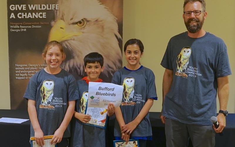 Photo courtesy of Chris May. Youth birding competition coordinator Tim Keyes poses with the Bufford Bluebirds team. For the first time in three years, the birding competition has returned, with the deadline for signups March 31.