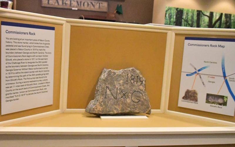 Megan Broome/The Clayton Tribune. Commissioners Rock, which depicts a surveying monument marking the boundary between Georgia and North Carolina dating back to 1819, is now on display at the Rabun County Historical Society. 