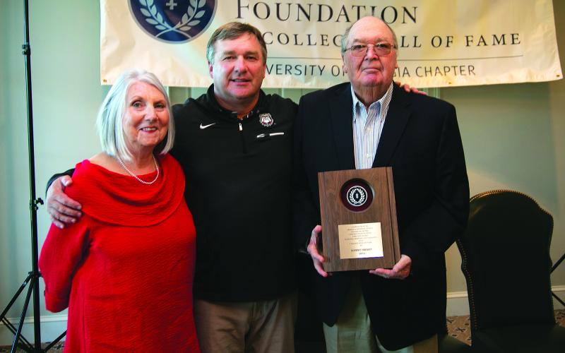 Submitted photo. Standing with his wife Sharon, Sonny Smart (far right) receives the Contribution to Amateur Football Award. A Rabun County resident, Smart is the father of current University of Georgia head football coach Kirby Smart (center). Among his career stops, Smart was the head football coach and athletic director at Rabun County High School.