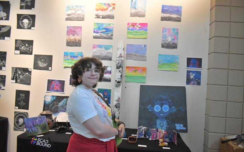 Megan Broome/The Clayton Tribune. Senior Rebekah Ramey showcases her art at the end-of-the-year show.