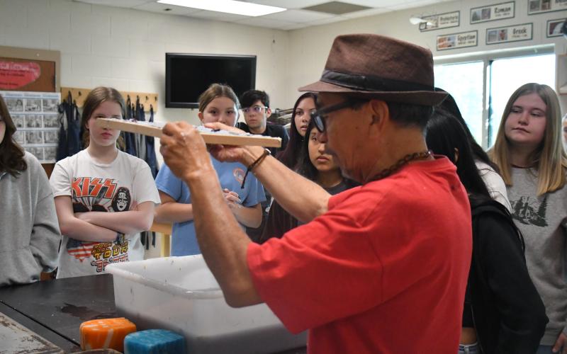 Megan Broome/The Clayton Tribune. Artist Javier Silverio, director of Taller Leñateros in Chiapas, Mexico, instructs students in the Rabun County High School art room April 21 on how to make paper using natural materials and dyes.