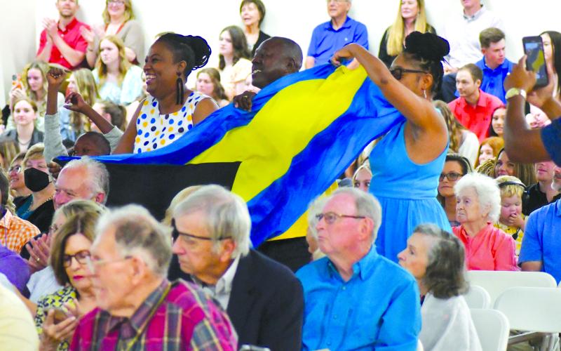 Enoch Autry/The Clayton Tribune. Friends and family proudly display the Bahamas national flag in honor of the graduates from that country during the Tallulah Falls School commencement exercises on May 19 for the Class of 2023.