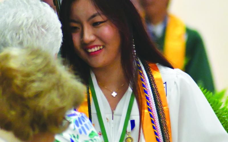 Enoch Autry/The Clayton Tribune. National Honor Society member Yixuan Wang is all smiles upon graduating.