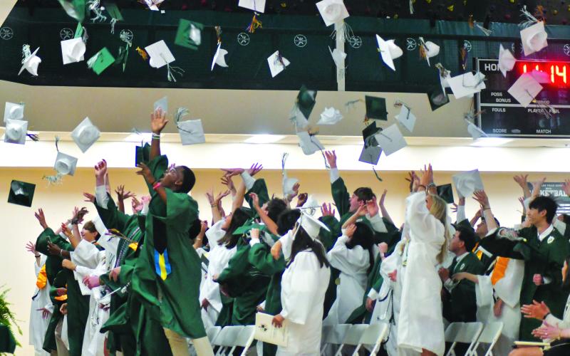 Enoch Autry/The Clayton Tribune. The Class of 2023 toss their caps into the air in celebration of graduating from the Tallulah Falls School.