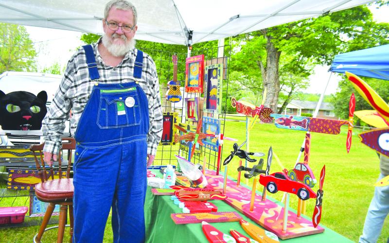 Megan Broome/The Clayton Tribune. Charlie Dingler, organizer of Dinglerfest along with Kip Ramey, showcases his artwork at the inaugural festival Saturday, May 6. Dingler showcased his “Whirligig” creations and his folk art creations. His medium is typically mixed-media and three dimensional. The event featured many exhibitors showcasing their beautiful handmade creations including folk art, pottery, paintings and much more.