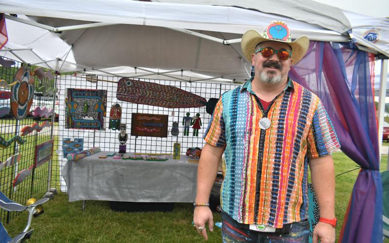 Megan Broome/The Clayton Tribune. Artist Chris Allison with Chicken Fried Folk Art colorfully displays his folk art at the inaugural Dinglerfest Saturday, May 6.