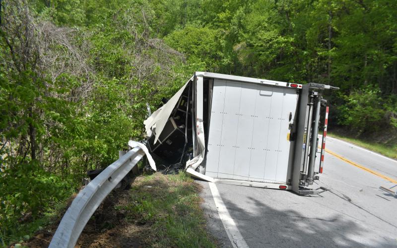 Megan Broome/The Clayton Tribune. First responders work the scene of a crash on Highway 246 involving a box truck that overturned and struck a guardrail Monday, May 1.