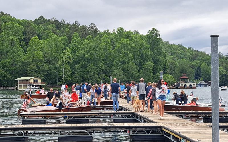 Megan Broome/The Clayton Tribune. Hundreds of people show out to LaPrade's Marina at Lake Burton to view wooden boats on display following the annual Memorial Day parade.