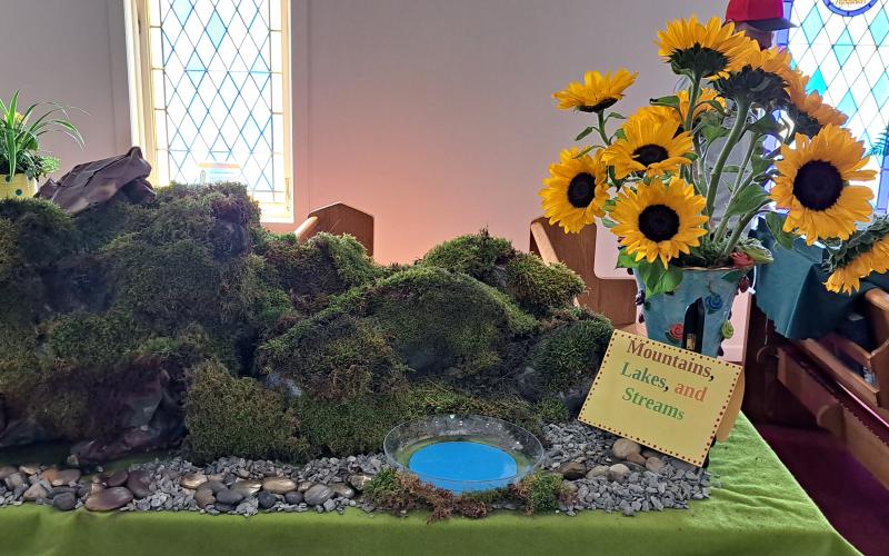 Megan Broome/The Clayton Tribune. This display features mountains, lakes and streams in a beautiful floral arrangement.