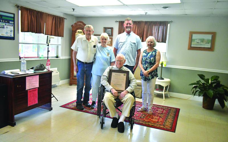 Megan Broome/The Clayton Tribune. Clayton Mayor Kurt Cannon presents 100-year-old Ervin Chastain with a proclamation declaring June 10, 2023, “Ervin Chastain Day,” “in recognition of Mr. Chastain becoming Clayton’s newest centenarian.” Pictured are Chastain with Cannon, son-in-law Jerry Gragg and daughters Charlie and Laura.