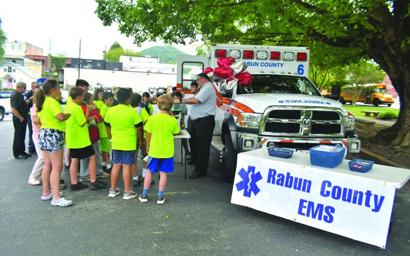 Megan Broome/The Clayton Tribune.  Rabun County EMS talks to students about the services they offer, how they help people, and gives them a look inside the ambulance. Fifth graders also got to see the stretcher and learn how it works. 