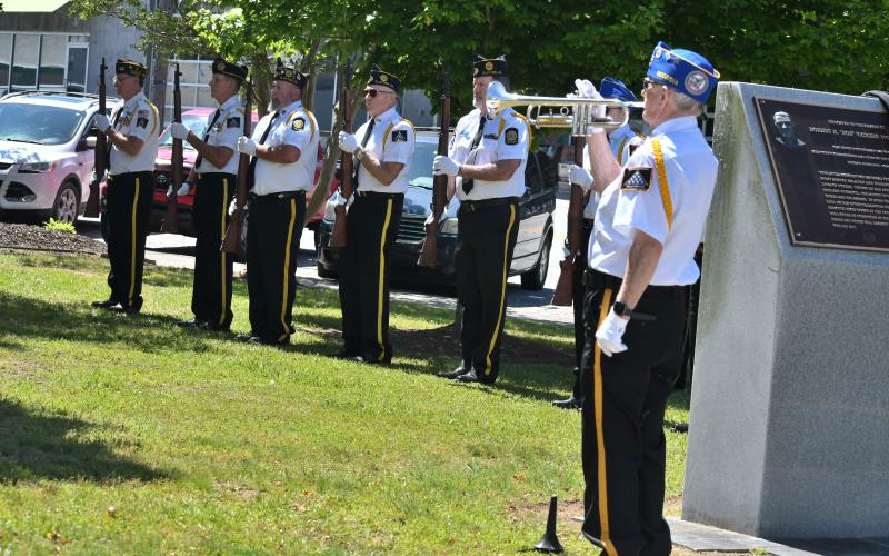 Megan Broome/The Clayton Tribune. Bugler Danny Stephens performs “TAPS” during the Memorial Day Ceremony at the courthouse with the Honor Guard in the background consisting of veterans from DAV. CH. 15; American Legion Posts 220 and 84 and VFW Posts 4570 and 7720.