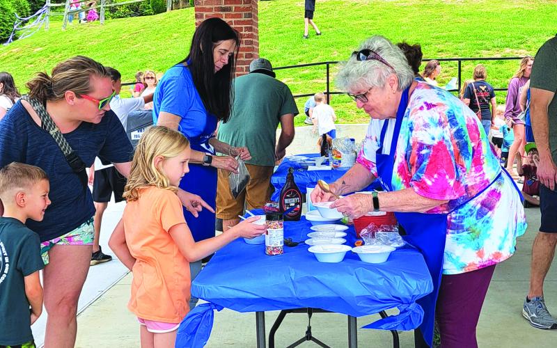 Megan Broome/The Clayton Tribune. Children enjoy an Ice Cream Sundae party at the Rabun County Public Library May 31 to kick off this year’s Summer Reading Program theme “All Together Now.” 