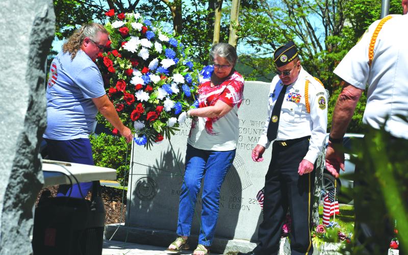Megan Broome/The Clayton Tribune. Pam Wheeler, founder of the organization Creating Ties That Bind: For Soldiers and Families Wounded By Loss; and Karen Trombley, state coordinator for Quilts of Valor Foundation, place the wreath to honor soldiers who passed at the Memorial Day Ceremony held at the Rabun County Courthouse Monday. Also pictured are Chaplain Dr. Kenneth Franklin, DAV. CH. 15 and SVCDR. DAV. Ch. 15 Doug Wayne in the foreground.