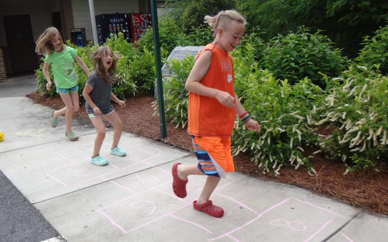 Submitted photo. These children are naturals at playing hopscotch, which was one of several games at the celebration.