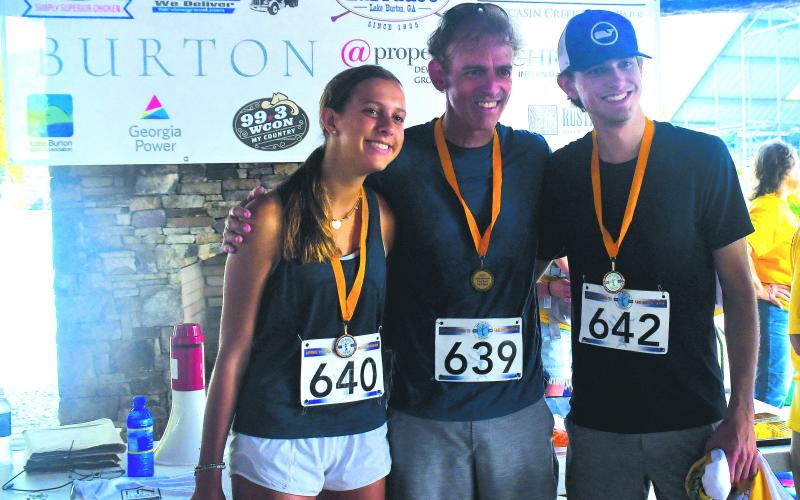 Luke Morey/The Clayton Tribune. From left, Avery, Sean and Max McGould of Palm Beach Gardens, Fla., pose with their medals for finishing top five in their age brackets. 