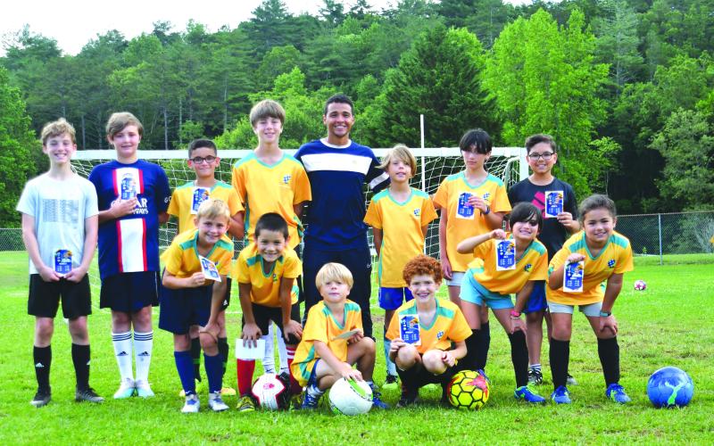 Enoch Autry/The Clayton Tribune. Lima poses with his campers at the end of a successful camp. This is the first year Brazilian United Corperation has come to Georgia, with 17 campers participating in the camp in Rabun County.