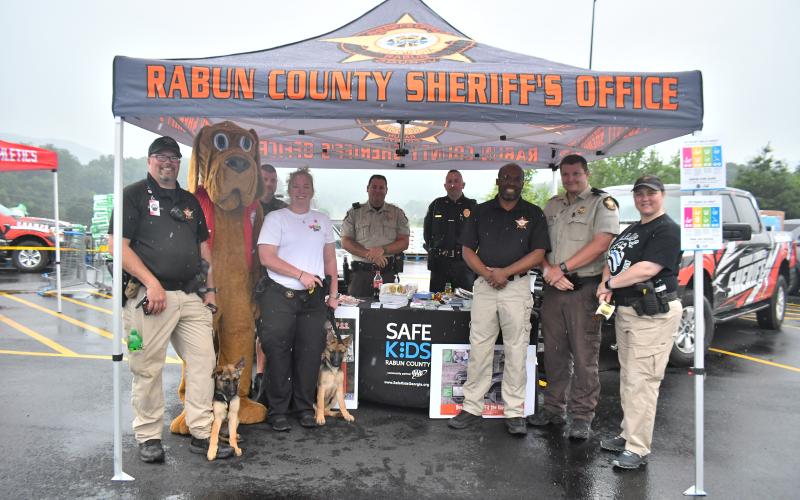 Megan Broome/The Clayton Tribune. Safe Kids Rabun County, Rabun County Sheriff's Office K-9s; C.H.A.M.P.S. and Rabun County Fire Services gave out important information during the Walmart grand reopening June 30.