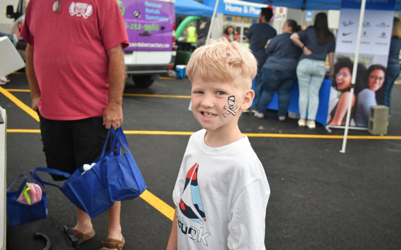 Megan Broome/The Clayton Tribune. Rex Church, 8, smiles after getting his face painted during the Walmart Grand Reopening event June 30.