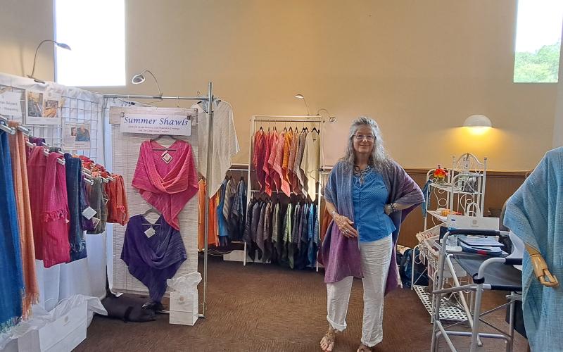 Megan Broome/The Clayton Tribune. Deborah Bryant showcases her handwoven, soft cotton accessories for everyday life, such as colorful summer shawls, at the annual Painted Fern Art Festival July 8 and 9 at the Rabun County Civic Center. Crowds enjoyed all the different types of items.