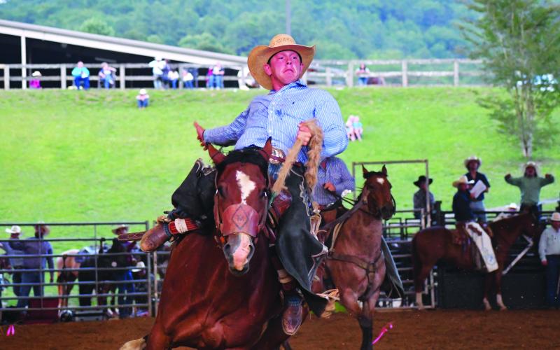 Luke Morey/The Clayton Tribune. Tristin McClain won the saddle bronc riding at the rodeo on Friday, June 30, at the Bar W Rodeo Company event. McClain also took first place on Saturday, July 1, with both rodeos held at the Rabun Arena. 