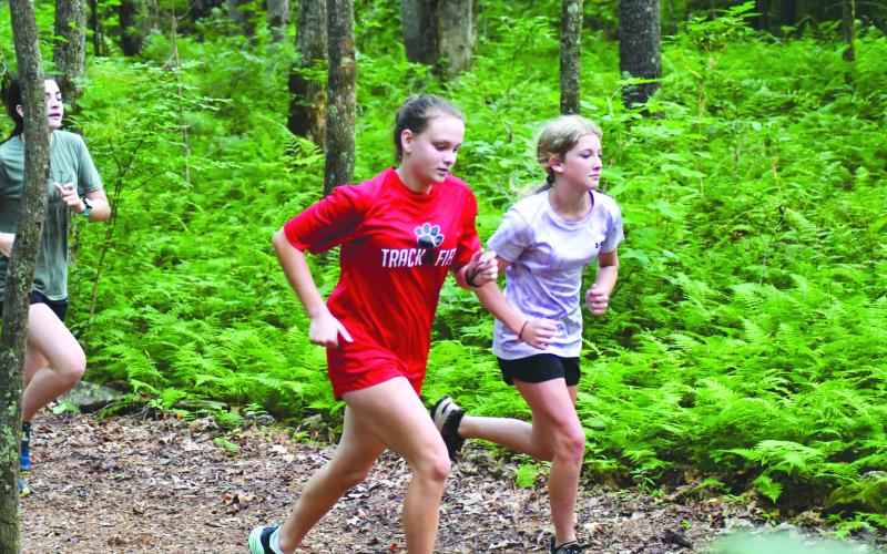 Enoch Autry/The Clayton Tribune. High schooler Lindsay Whitmire and middle schooler Annebell Coleman navigate the on-campus course. 