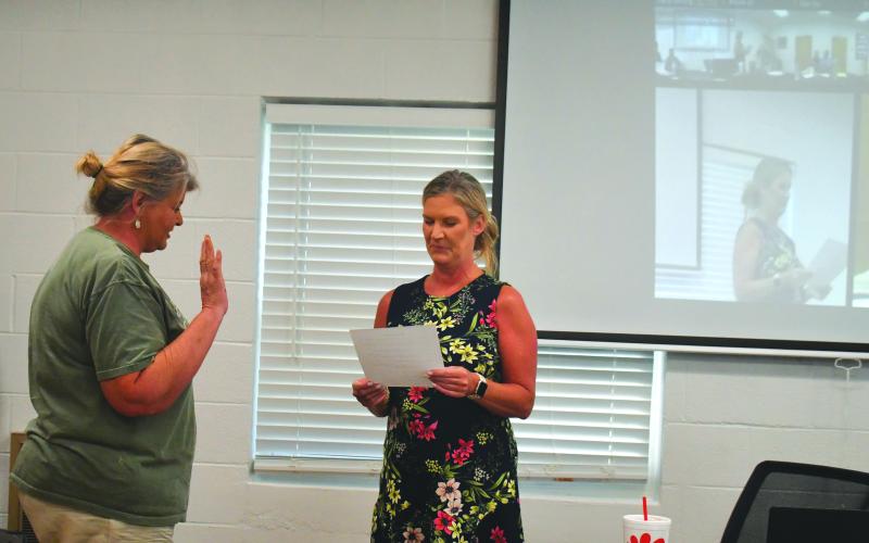 Megan Broome/The Clayton Tribune. Tallulah Falls Town Clerk Linda Lapeyrouse gives newly appointed Council Member Cissy Henry the oath of office as she is sworn in during the town council meeting Aug. 16. Henry fills the seat left vacant by Tom Tilley until a Nov. 7 special election.
