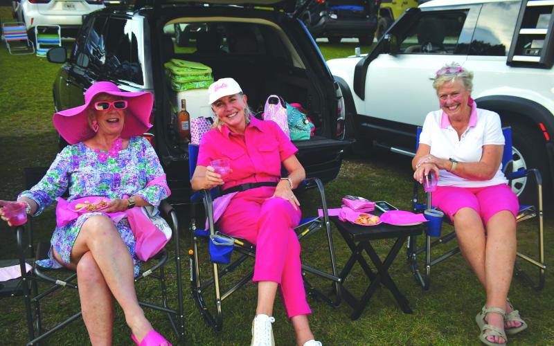 Enoch Autry/The Clayton Tribune. Margaret Boland, Sharon Abdi and Margaret Watt enjoy themselves at the Aug. 2 Barbie-themed event at the Tiger Drive-In. The food and the clothes all had elements of the color pink for the evening.