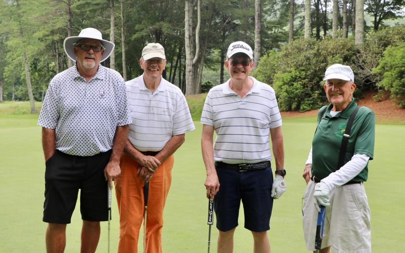Submitted photo. Ken Anders, Steve Mason, Tom Kellogg and Milt Gillespie get in some work with their putters at the tournament fundraiser. Left: Ken Walton, Vickie Heher and Patrick Heher watch as Roberta Walton lines up her putt during the Sid Weber Memorial Cancer Fund Annual Golf Tournament. Ken Walton is the current SWMCF president.