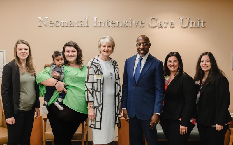 Submitted photo. From L-R: Laurisa Guerrero, executive director of Georgia Council for Recovery; Katelyn Burton holding son Mykigh Burton, Georgia Council for Recovery program participant; Carol Burrell, president and CEO of NGHS; Raphael Warnock, United States Senator; Aubrey Williams, Coordinator of neonatal community outreach at NGMC; Brittany Smith, nurse director for the neonatal intensive care unit at NGMC.