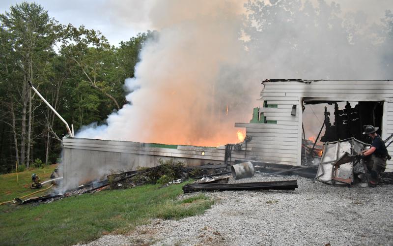 Megan Horn/The Clayton Tribune. Rabun County firefighters battle a structure fire on Sidetrack Lane on Aug. 27.