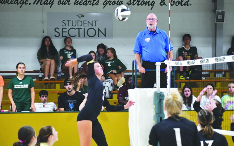 Wade Cheek/The Clayton Tribune. RGNS senior Peyton Brady rises over the net to complete a kill against RCHS on Aug. 31. The Eagles are currently 13-7.