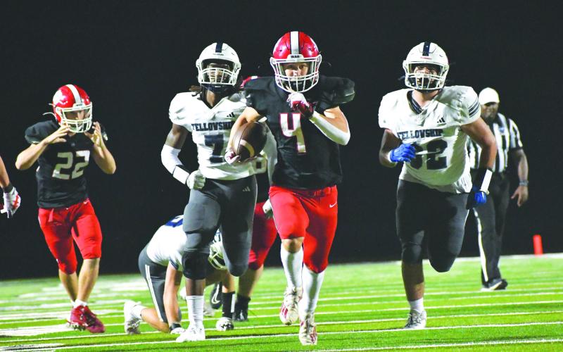 Wade Cheek/The Clayton Tribune. RCHS sophomore running back Noah English sprints toward the end zone amid pursuit from multiple Paladin defenders in the Wildcat’s win over FCS. English tallied over 100 yards on the ground in last Friday’s 42-28 win over Fellow Christian School. 