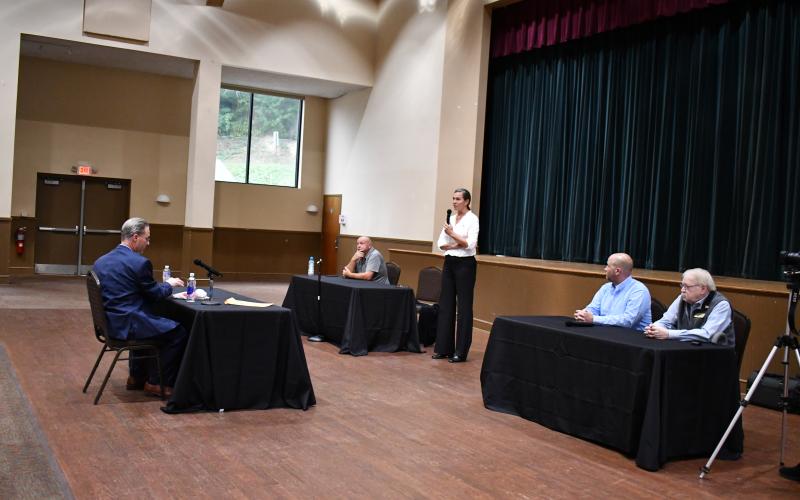 Megan Horn/The Clayton Tribune. Sarah Gillespie responds to a question during the election debate. Gillespie is running from Post 4 against incumbent David Cross (seated beside Gillespie). Candidates for Post 3 Andrew Green and Tony Allen are seated on the right. Moderator Enoch Autry, publisher of The Clayton Tribune, is to the far left.