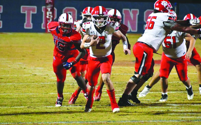 Wade Cheek/The Clayton Tribune. Sophomore quarterback Ty Truelove escapes the pocket against Brooks County. Truelove had a rushing and passing touchdown in the Nov. 24 game in Quitman.