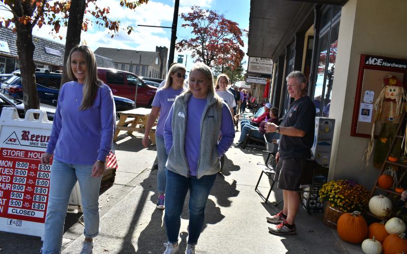 Megan Horn/The Clayton Tribune. Fight Abuse in the Home (F.A.I.T.H.) organized many events during October for Domestic Violence Awareness Month, including a Hope Walk where many community members walked in downtown Clayton while local businesses stood in solidarity holding candles on the sidewalk to bring awareness. 