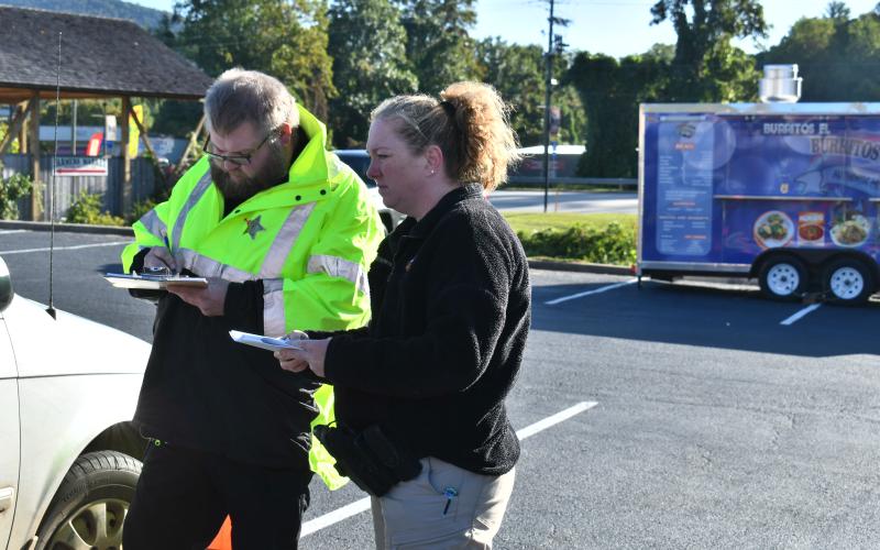 Megan Horn/The Clayton Tribune. Clayton Police Officer Andy Beck and SRO Lisa Thompson perform Car Seat Safety Checks as Car Seat Safety Technicians during the Faith and Blue event Oct. 7. 