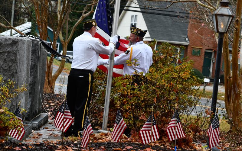 Megan Horn/The Clayton Tribune. SVCDR David Cross, American Legion Post 220, and CDR Gary Cantwell, V.F.W. Post 4570, raised and then lowered the flag to half mast while veterans saluted in solidarity.