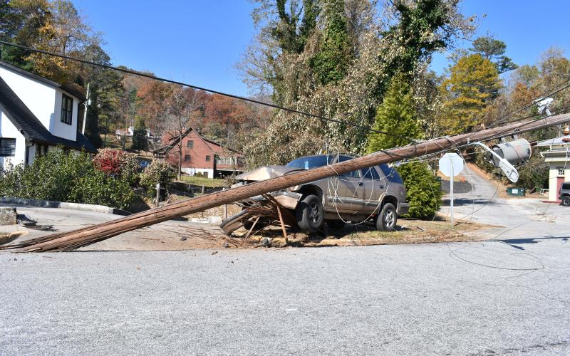 Megan Horn/The Clayton Tribune. A vehicle wrecked on North Main Street at Paris Street and damaged one Georgia Power pole and knocked another out completely. The road was closed for about four hours as emergency personnel worked the scene and Georgia Power crews replaced the damaged poles. 