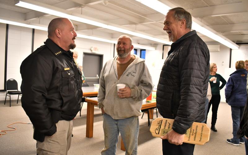 Megan Horn/The Clayton Tribune. Clayton Police Department Chief Andy Strait converses with council members David Cross and John Bradshaw during a special reception Tuesday honoring outgoing council members Woody Blalock, David Cross and John Bradshaw for their years of service to the city.