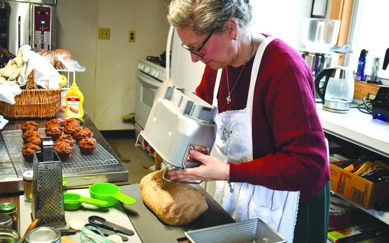 Megan Horn/The Clayton Tribune. Anne Weingartz kneads fresh dough made from wheat she milled herself at Quizzical Farm Bakery in Rabun Gap.