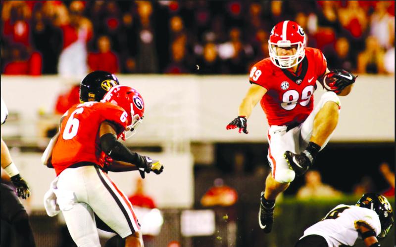 Photo courtesy of Woerner family. Charlie Woerner hurdles a University of Missouri defender while playing for the University of Georgia football team. Woerner played for the Bulldogs from 2016-2019. 