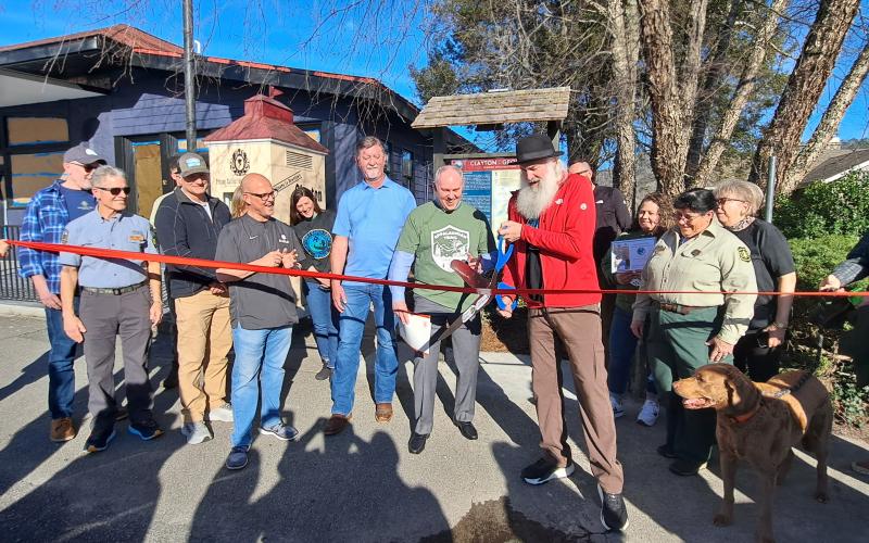 Megan Horn/The Clayton Tribune. Forward Rabun/Rabun County Chamber of Commerce cuts the ribbon on the new Appalachian Trail (AT) Community Kiosk located near the Rock House on Main Street in Clayton March 7. Community citizens, officials from the City of Clayton and county, and AT Community Committee members participated in the event. 